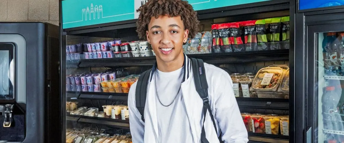 Student smiling in middle of store