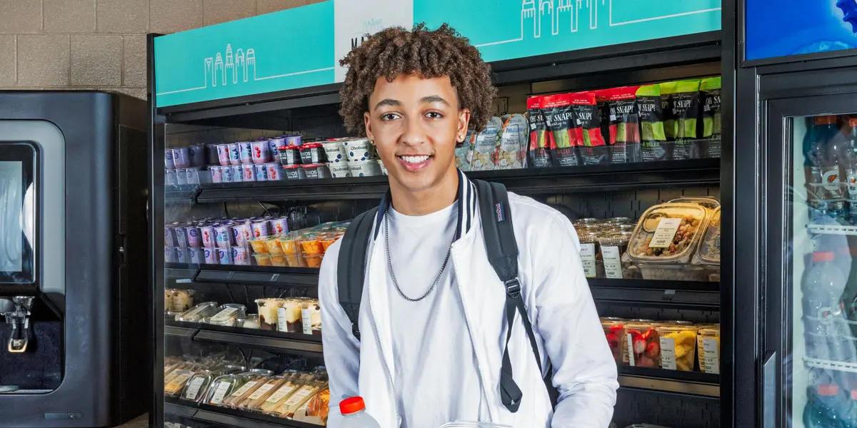 Student smiling in middle of store