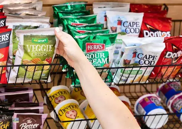 Hand grabbing a bag of chips